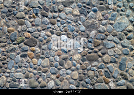 cemented small pebble round stone rock wall or floor Stock Photo