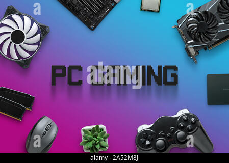 Assembling gaming computer concept with text in the middle. PC gaming composition with computer components on purple, blue background. Stock Photo