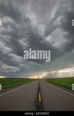 Storm clouds over the road in eastern Montana, United States Stock Photo