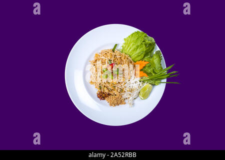 Asian Thai food on white plates with purple background with copy space Stock Photo