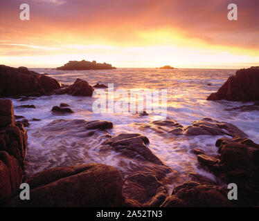 Channel Islands. Guernsey. Rocky coast at sunset. Stock Photo