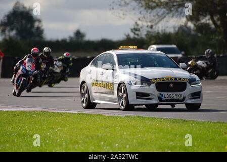 Dalton on Tees, England, 12 October 2019. The safety car leads the riders around the hairpin during a Metzeler Newcomer 1000 and Lind Triumph London Cup race in the No Limits meeting at Croft Circuit. Stock Photo