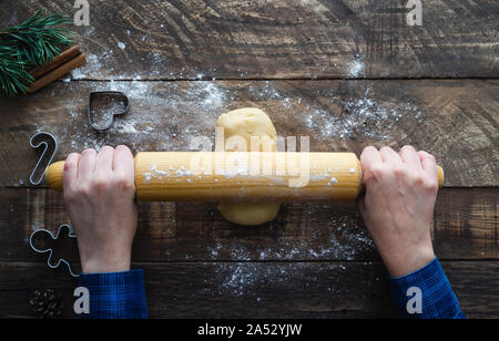 Preparation of cookie dough on wooden background. Top view. Christmas concept. Stock Photo