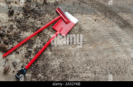 Gardening tools and earth on dark wooden background. Copy space Stock Photo