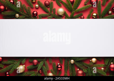Christmas background with white note paper. Decorative border of fir branches and Christmas balls Stock Photo