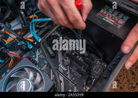 Valencia, Spain - August 12, 2019: Installing PC components. AMD Ryzen 3700x processor in the X570 motherboard socket. New Zen 2, 7 nanometer desktop Stock Photo