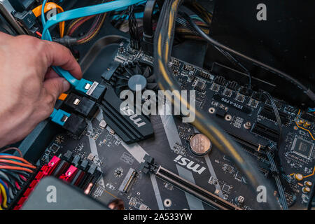 Valencia, Spain - August 12, 2019: Installing PC components. AMD Ryzen 3700x processor in the X570 motherboard socket. New Zen 2, 7 nanometer desktop Stock Photo