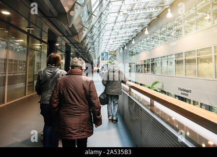 Strasbourg, France - Nov 23, 2017: Rear view of senior patients walking inside the NHC Nouvel Hopital Civil in Strasbourg near Cardiology exams sections Stock Photo