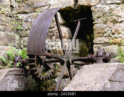 old machine parts remind of the existence of the old water mill at Dolny Mlyn in Bohemian Switzerland national park Stock Photo