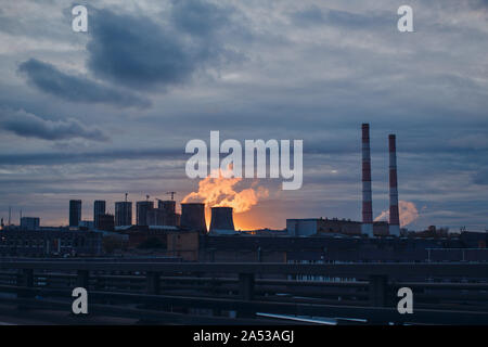 Industrial landscape and smoke from the chimneys on sunset background Stock Photo