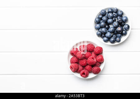Blueberries and raspberries. Tasty mix of berries in bowl. Top view. Stock Photo
