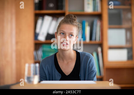 student learning in a library thinking Stock Photo