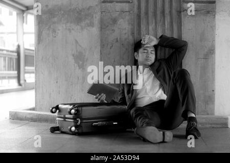 Stressed asian businessman bankrupt with sitting at outdoor. Stock Photo