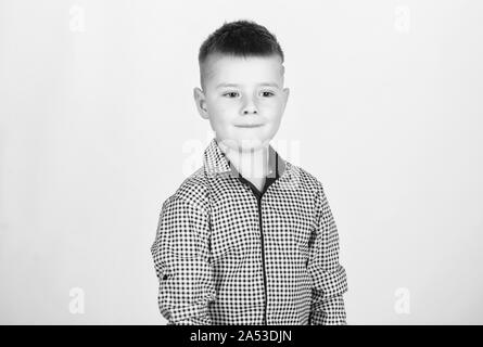 Boy modern hairstyle wear formal style shirt light background. Confident guy enjoy fashionable outfit. Try being handsome and stylish. Know lot about style. Found his style. Adorable small kid. Stock Photo