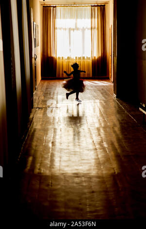 KHARKIV, UKRAINE - MARCH 6, 2019: Silhouette of a girl in a dark corridor Stock Photo