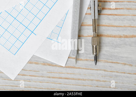 Close-up view of compass on graph paper Stock Photo