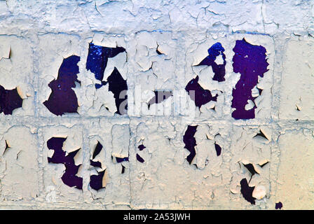 Cracked soft paint on dark blue tiles, grunge horizontal shabby background detail close up Stock Photo