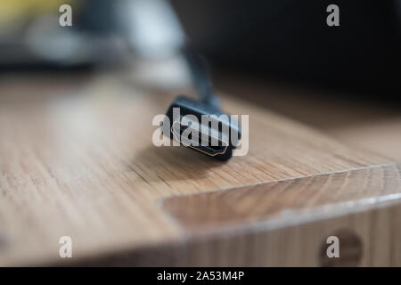 Close up of a black HDMI male cable (1, 2 or 5 meters long). High technology device that transmits hight quality audio & video. Stock Photo