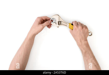 Close up view of a man's hands working with adjustable wrench, isolated on white background Stock Photo