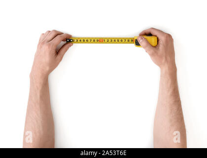 A Close Up Of A Yellow Metric Tape Measure With A White Hand