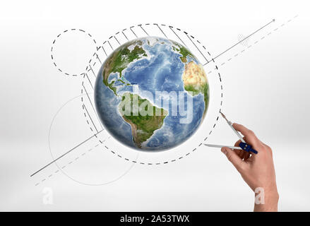 Man's hand holding engineering compass measures the distance near Globe. Stock Photo