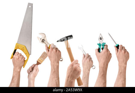 Set of people's hands holding different building tools isolated on white background Stock Photo