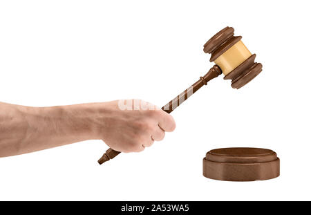 A large male hand holds a wooden judge gavel above a round sound block isolated on a white background. Stock Photo