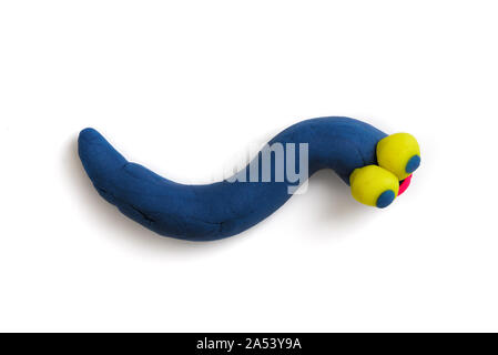 Bright blue plasticine worm with big yellow eyes, isolated on the white background. Stock Photo