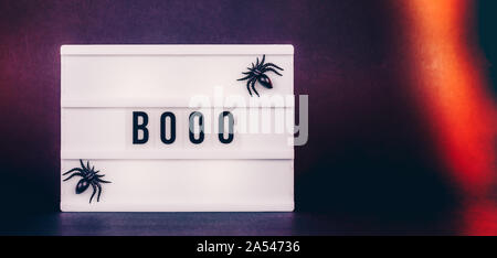 Halloween themed cinema light box on the dark toned background with decorative spiders. Banner wide screen format Stock Photo