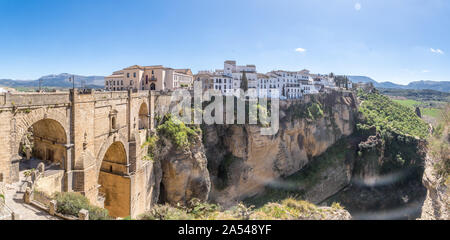 Ronda Spain aerial view of medieval hilltop town surrounded by walls and towers with famous bridge over gorge Stock Photo