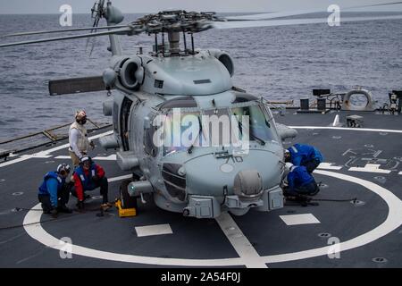 MEDITERRANEAN SEA (Oct. 10, 2019) — Sailors aboard the Arleigh Burke-class guided-missile destroyer USS Porter (DDG 78) chalk and chain an MH-60R Sea Hawk helicopter, attached to Helicopter Maritime Strike Squadron (HSM) 72, to the flight deck of the ship in the Mediterranean Sea Oct. 10, 2019. Porter, forward-deployed to Rota, Spain, is on its seventh patrol in the U.S. 6th Fleet area of operations in support of U.S. national security interests in Europe and Africa. (U.S. Navy photo by Mass Communication Specialist 3rd Class T. Logan Keown/Released) Stock Photo