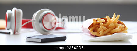 French fries with headphones lying on Stock Photo