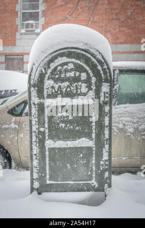 Post office mail box covered in snow, on a cold snowy winter day in New York City Stock Photo