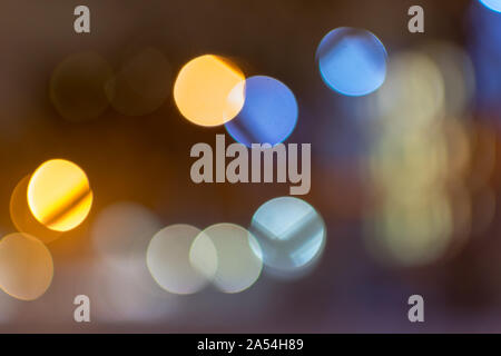 Abstract multicolored bokeh balls, floating across a dark background Stock Photo