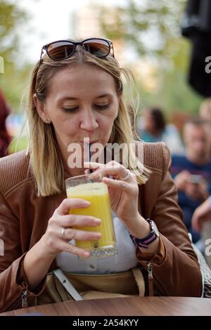 Portrait of the mature woman sitting in the restaurant drinking juice Stock Photo