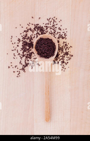 The chocolate topping  of baking in wooden spoon on wooden table . Stock Photo