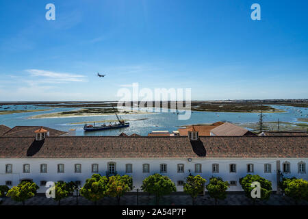 Panoramic view from the tower bell of Faro Cathedral (Church of Santa Maria) with a plane landing at Faro airport, Algarve, Portugal Stock Photo