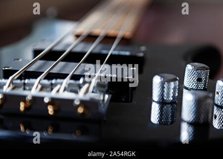 Umea, Norrland Sweden - October 5, 2019: black shiny electric bass with four strings Stock Photo