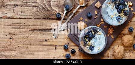 Blueberries and yogurt chia pudding parfait in glasses top view Stock Photo