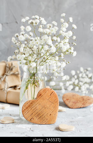 Bouquet of small white flowers and wooden hearts Stock Photo by katrinshine