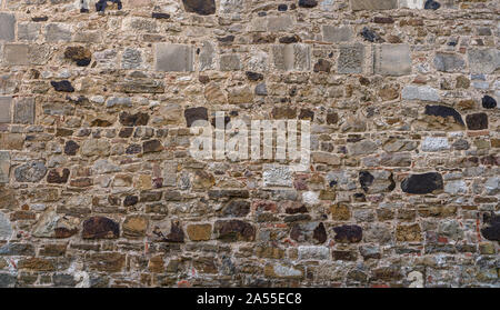 Very old, gray brown stone wall Stock Photo