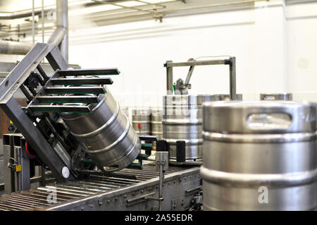 beer barrels in the filling process in a brewery - beer production in the modern food industry Stock Photo