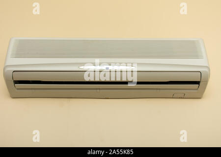 Air conditioner unit inside a home or apartment on the wall preparing to cool people down from the heat. Stock Photo