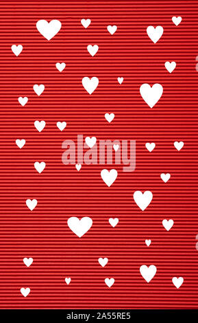 Valentines  day concept. Red color corrugated cardboard paper and white hearts background and texture Stock Photo