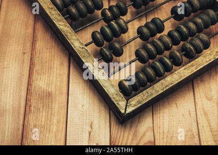 Close up Beautiful old  Vintage wooden  abacus on. red wood table. Stock Photo