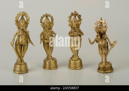 Four idols of Lord Ganesh playing musical instruments, made of brass wire by tribal artists of Orissa State, in standing posture Stock Photo
