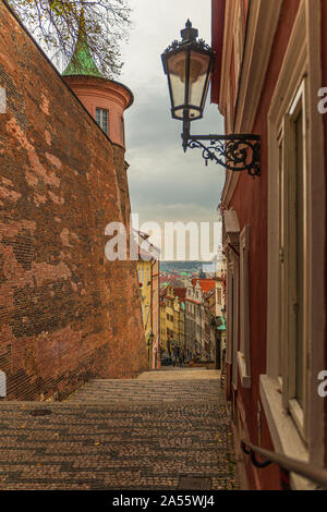 Old medieval narrow cobbled street in Hradcany district, Prague - Czech Republic Stock Photo