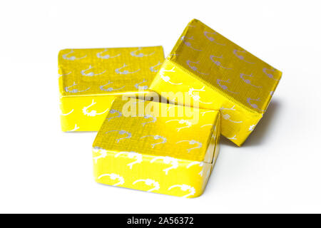 Three wrapped chicken stock cubes. UK Stock Photo