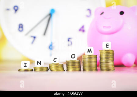 income growth money coins on table / Pile of golden coin stack step up growing growth saving concept with piggy bank and time clock money financial bu Stock Photo