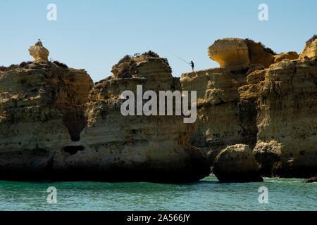 Fisherman fishing on the cliffs in Portugal Stock Photo